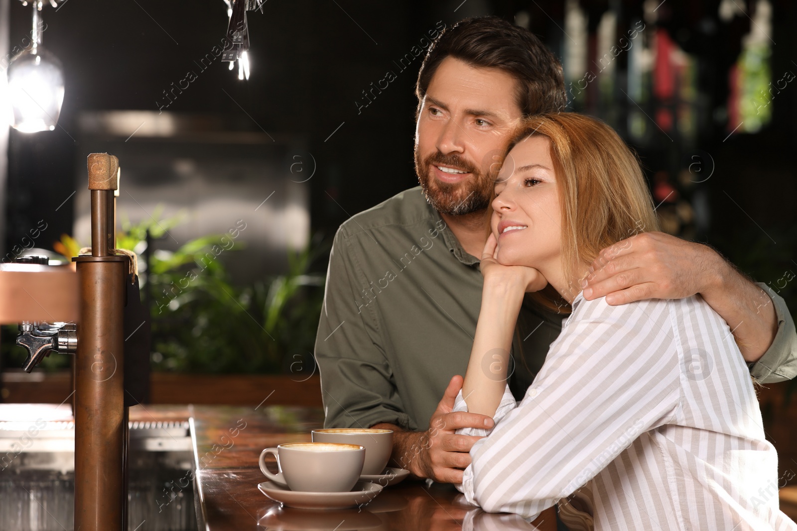 Photo of Romantic date. Lovely couple spending time together in cafe