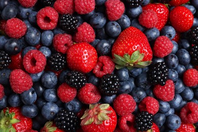 Photo of Different fresh ripe berries as background, top view