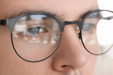 Photo of Man wearing glasses on blurred background, closeup