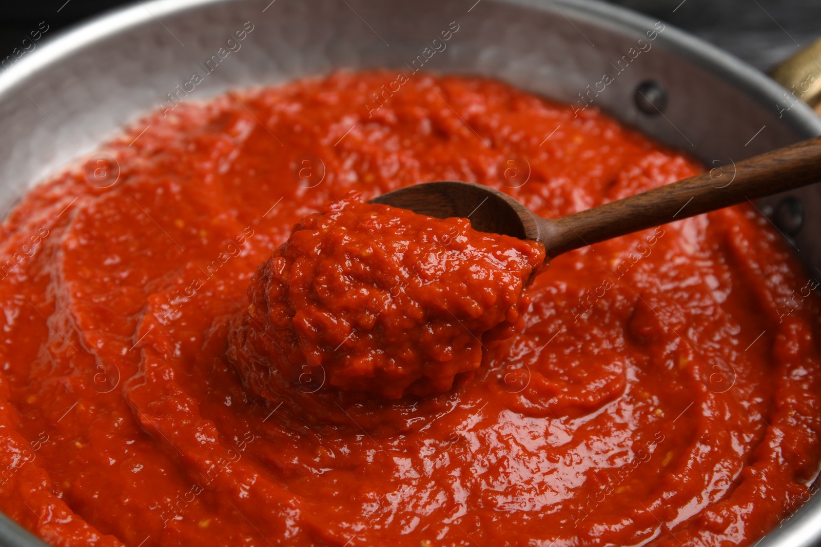 Photo of Delicious tomato sauce in pan, closeup view