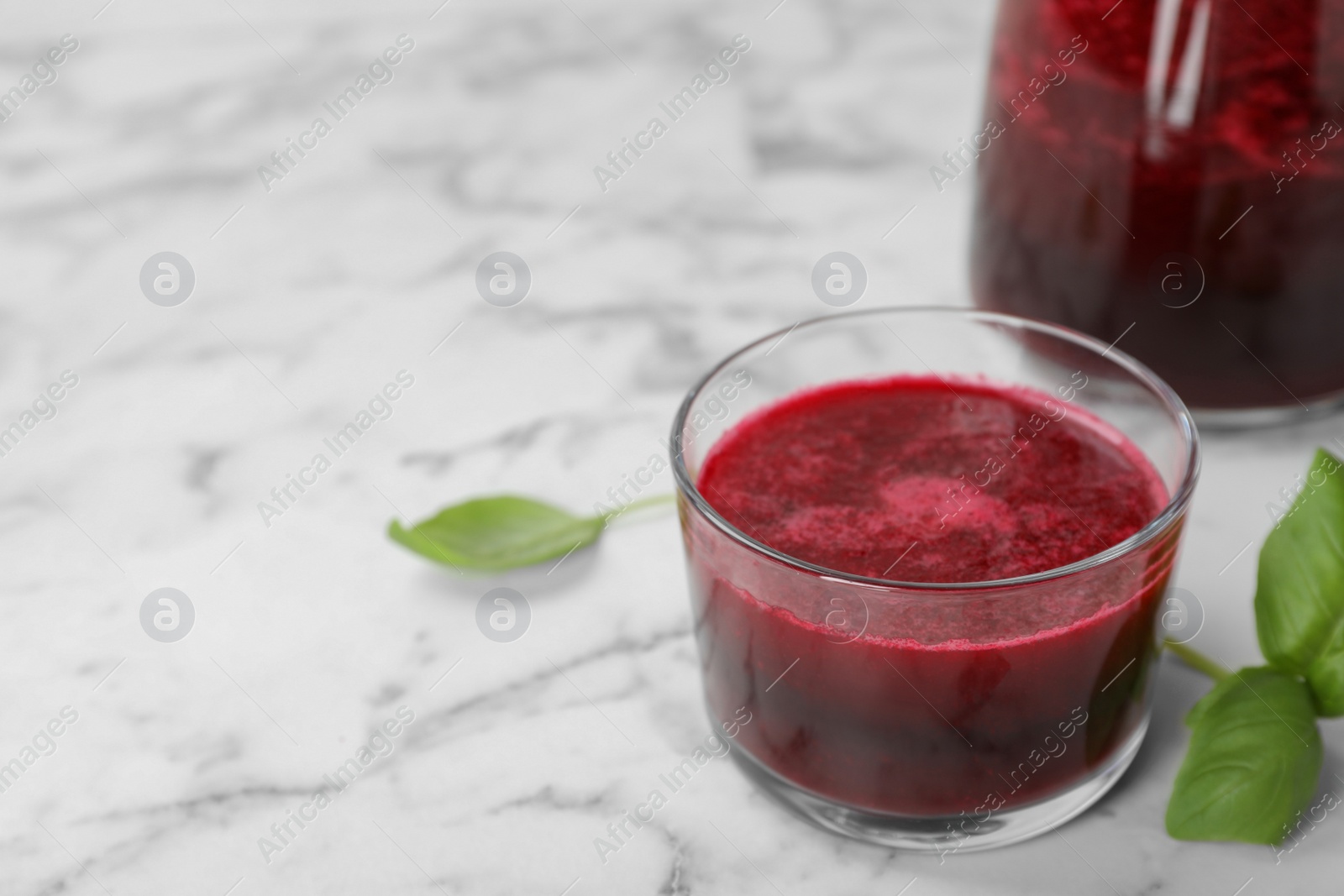 Photo of Glass of fresh natural beet juice on table