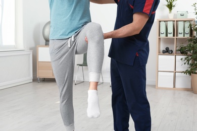 Physiotherapist working with patient in clinic, closeup. Rehabilitation therapy