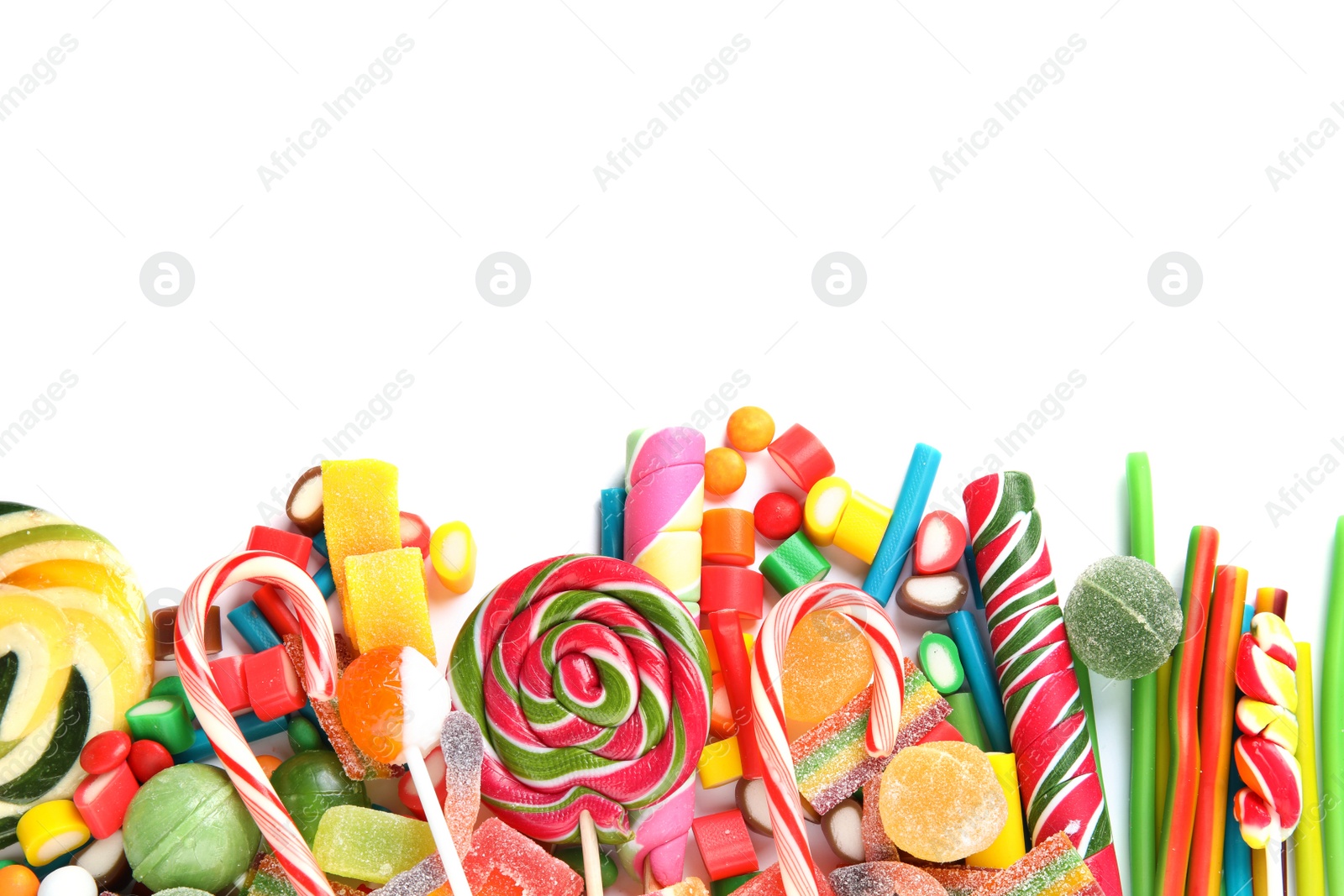 Photo of Many different yummy candies on white background, top view. Space for text