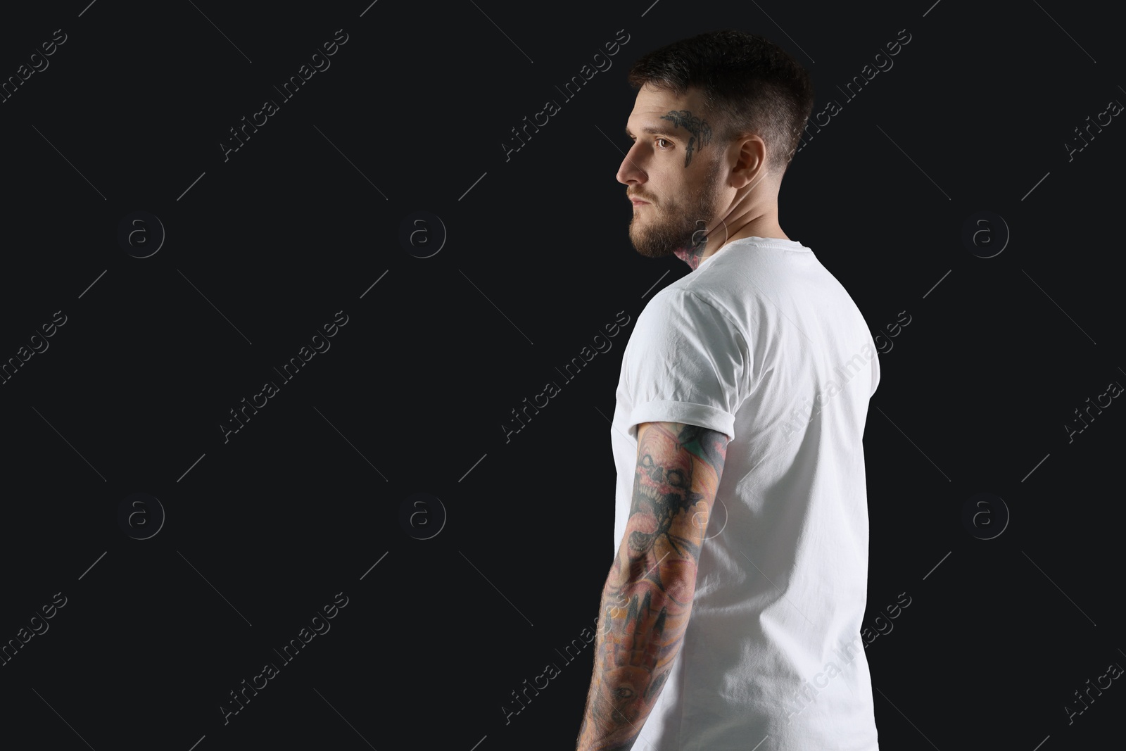 Photo of Handsome hipster man on black background. Space for text