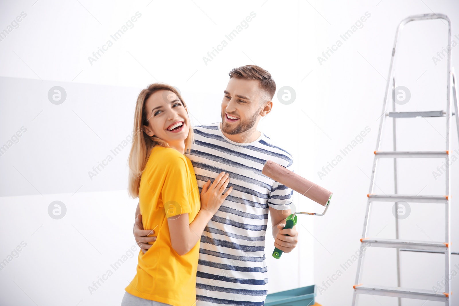 Photo of Young couple during apartment renovation, indoors