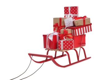Photo of Sleigh with gift boxes on white background