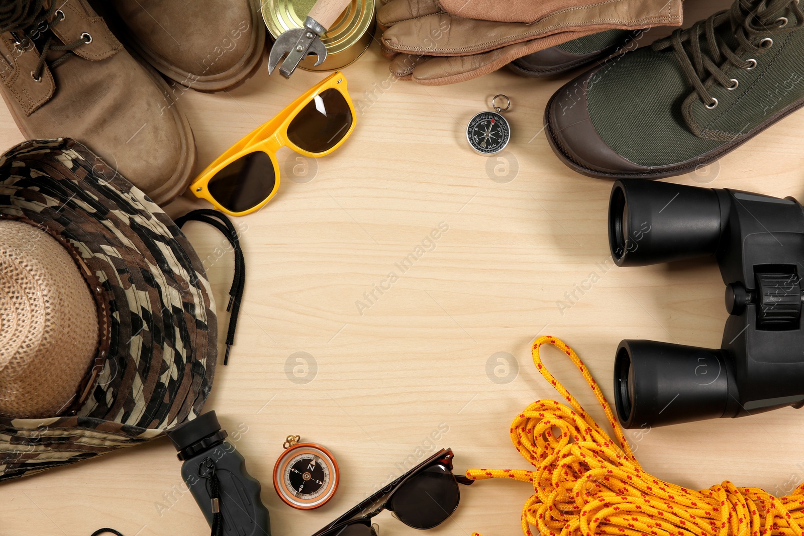 Photo of Flat lay composition with camping equipment on wooden background