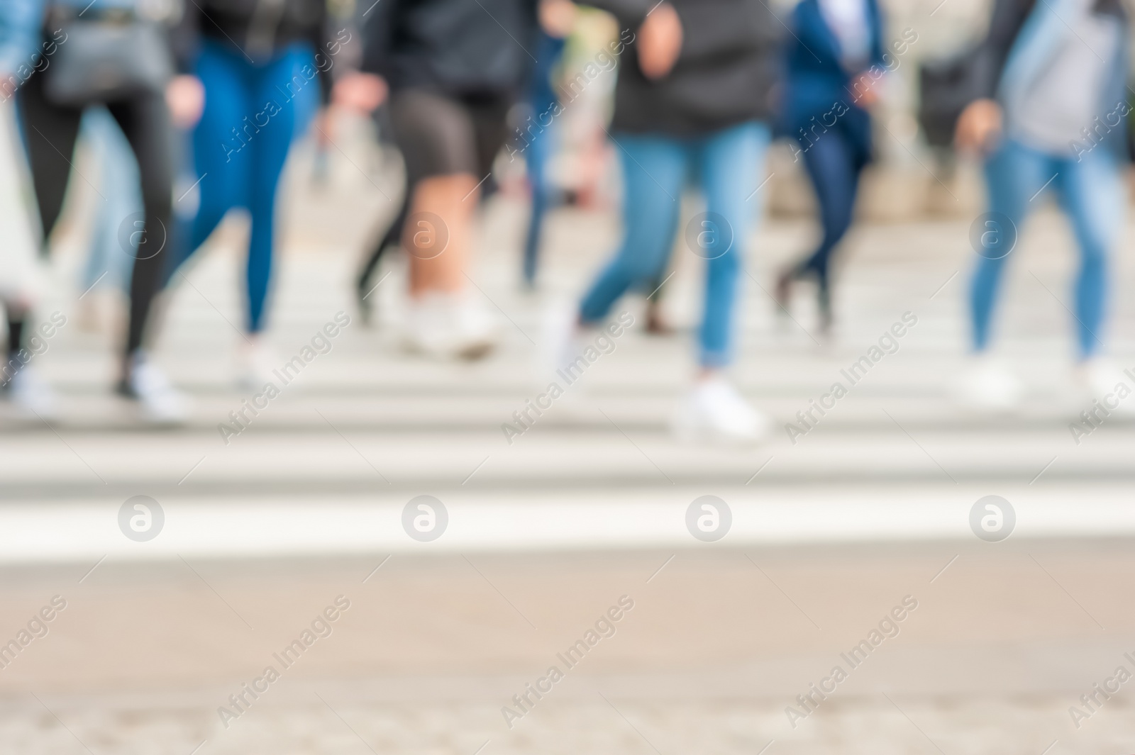 Photo of People crossing street outdoors, closeup. Blurred view