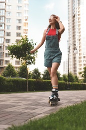 Beautiful young woman with roller skates having fun outdoors