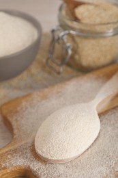 Photo of Spoon with quinoa flour on wooden table, closeup