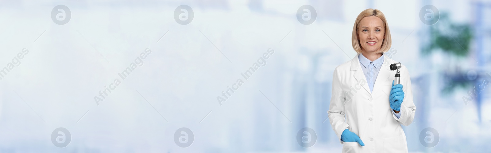 Image of Professional dermatologist with dermatoscope on blurred background, space for text. Banner design