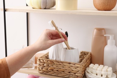 Photo of Bath accessories. Woman organizing personal care products indoors, closeup