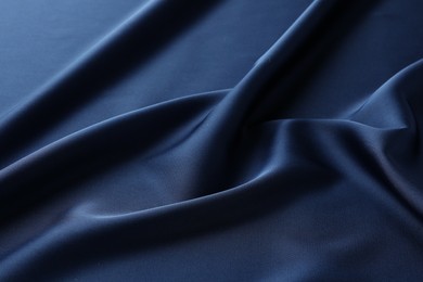 Photo of Texture of blue crumpled silk fabric as background, closeup