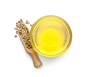 Bowl with hemp oil and seeds on white background, top view