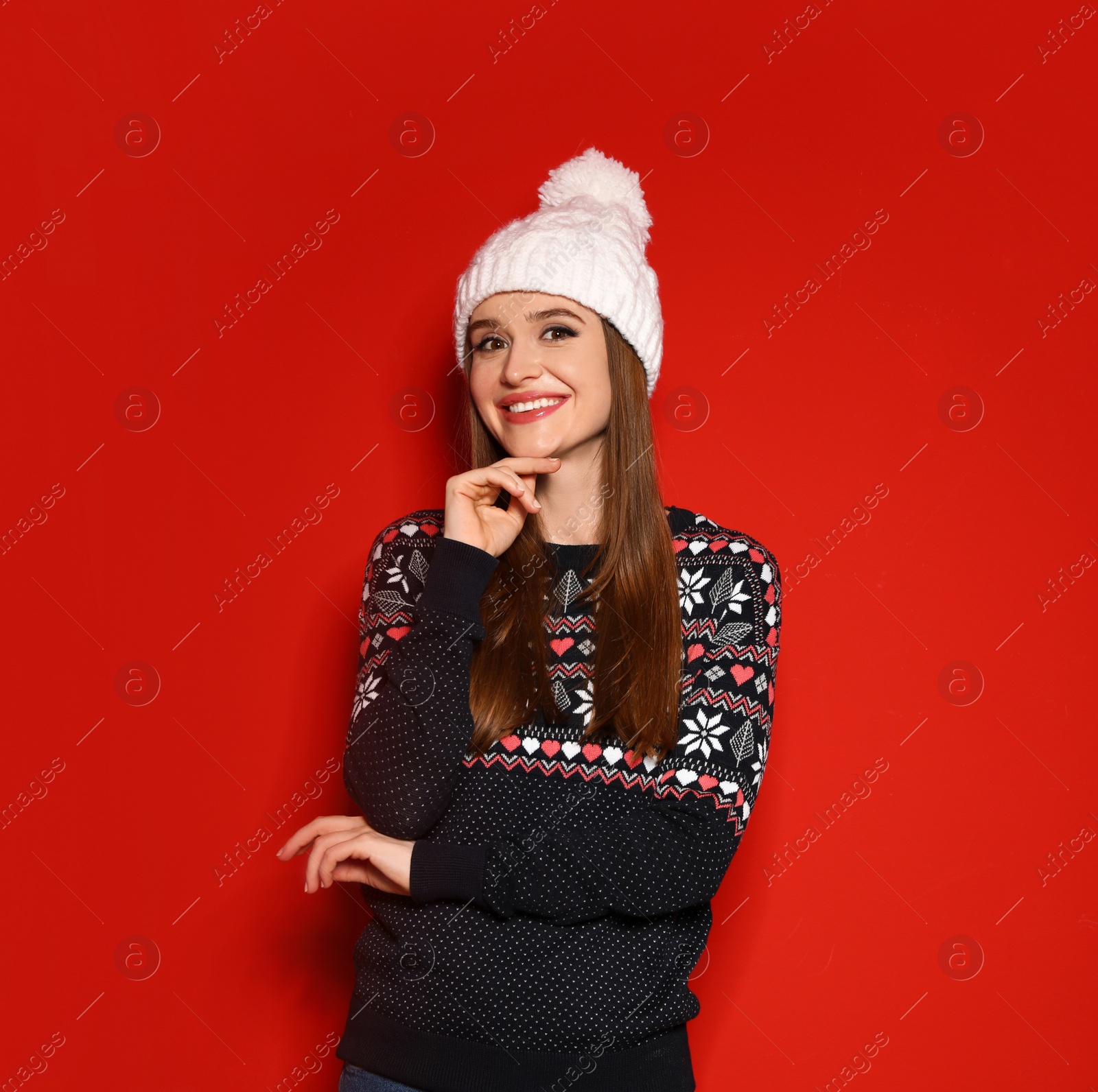 Photo of Young woman wearing Christmas sweater on red background