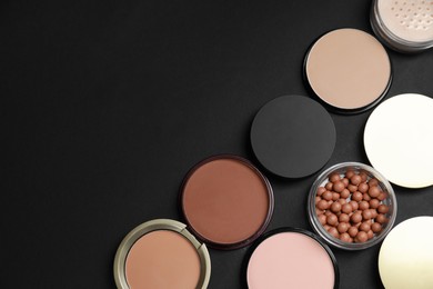 Photo of Different face powders on black background, flat lay. Space for text