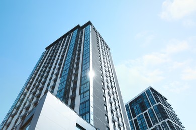 Photo of Low angle view of modern buildings against blue sky