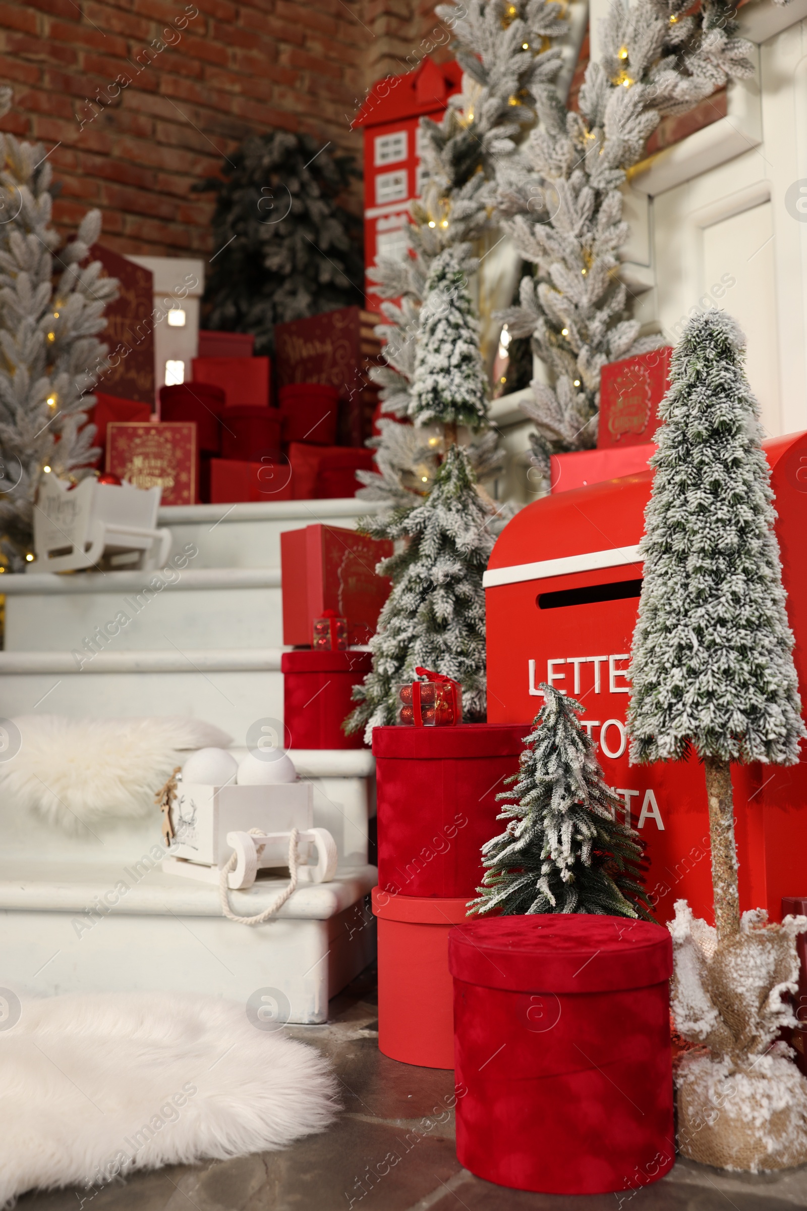 Photo of Christmas tree, gift boxes and festive decor indoors. Interior design