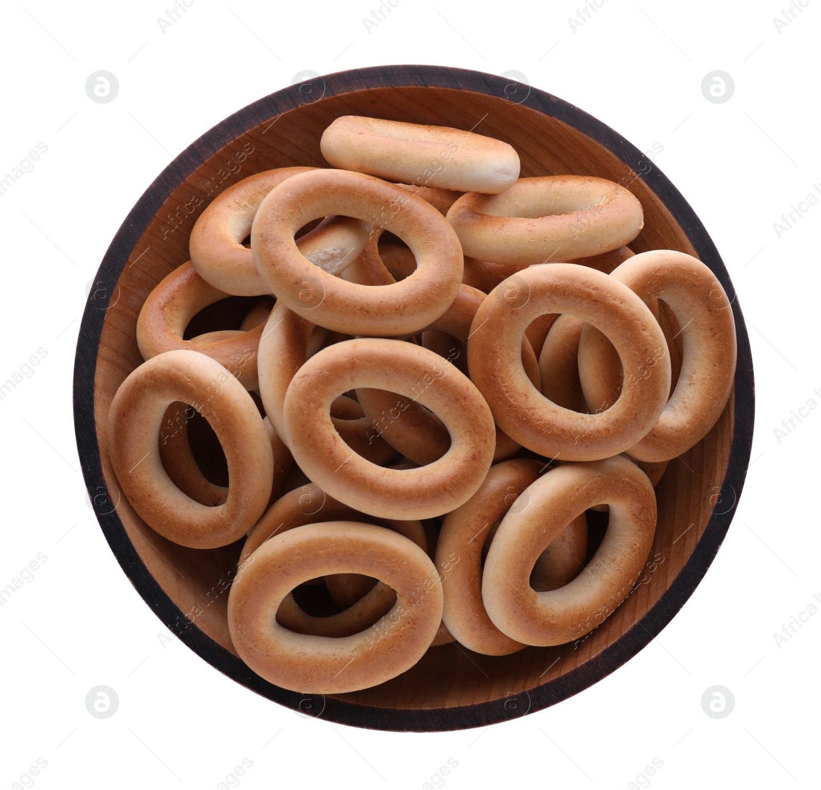 Photo of Bowl with tasty dry bagels (sushki) isolated on white, top view