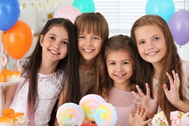 Photo of Happy children at birthday party in decorated room