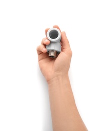 Photo of Plumber holding pipe fitting on white background, closeup