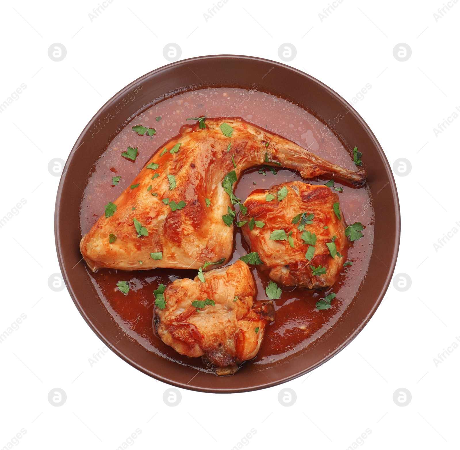 Photo of Tasty cooked rabbit meat with sauce and parsley isolated on white, top view