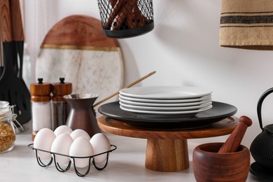 Photo of Set of different dishes and eggs on countertop in kitchen