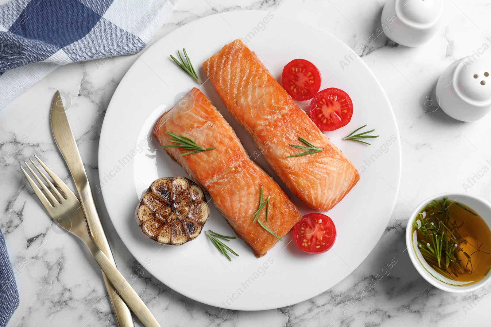 Photo of Delicious roasted fish served on white marble table, flat lay