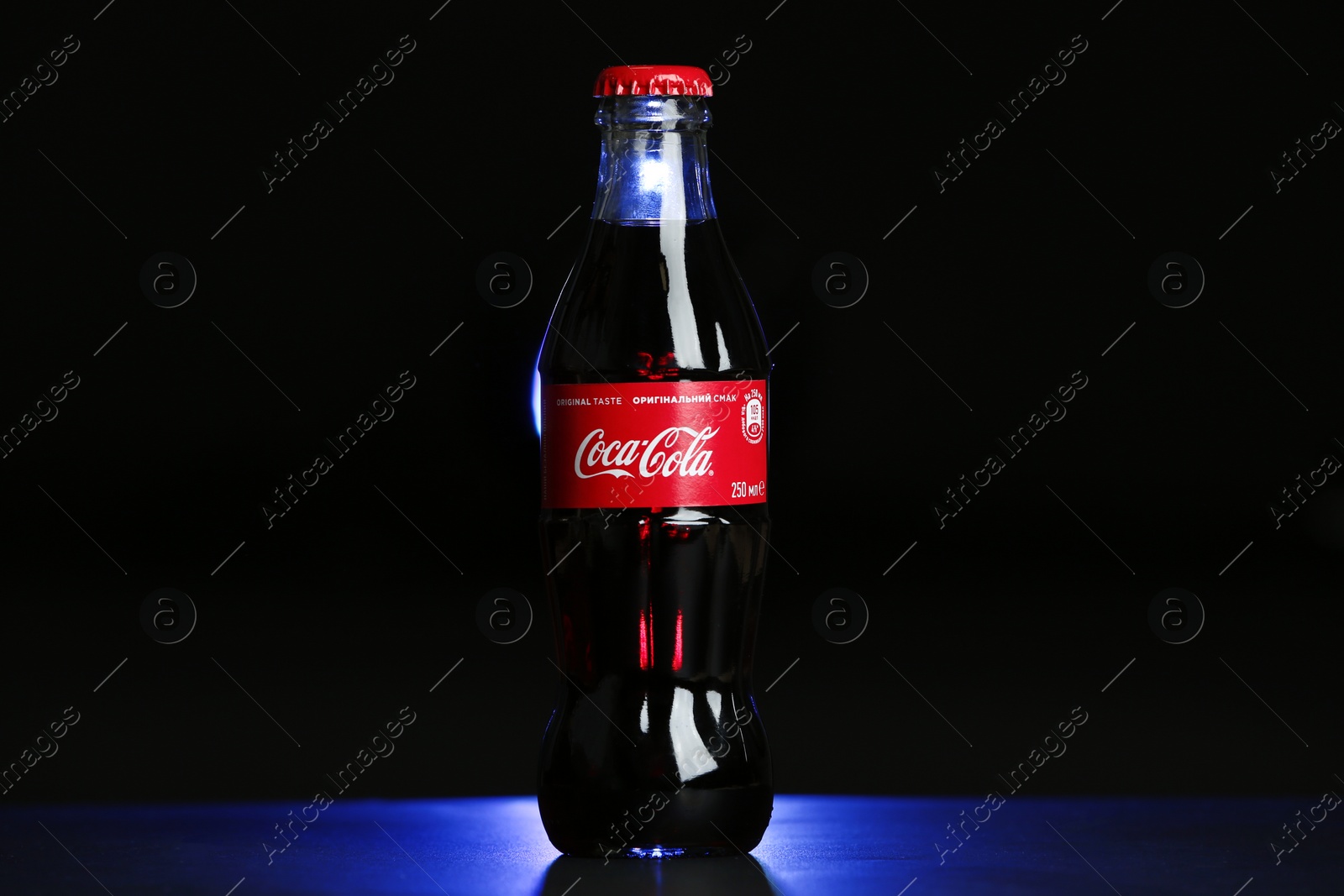 Photo of MYKOLAIV, UKRAINE - NOVEMBER 14, 2018: Bottle of Coca-Cola on dark background