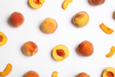 Composition with fresh sweet peaches on white background