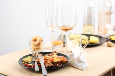 Photo of Food leftovers after party on wooden table