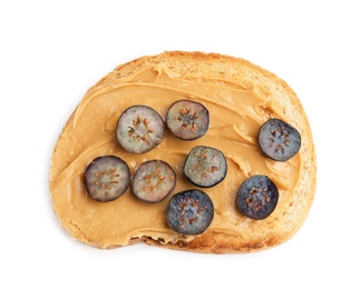 Slice of bread with peanut butter and blueberries on white background, top view