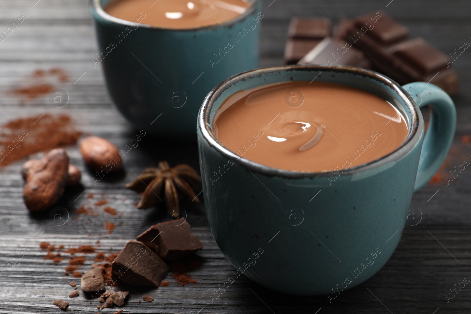 Photo of Yummy hot chocolate on black wooden table