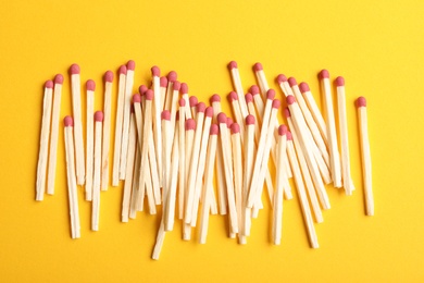 Photo of Wooden matches on color background, flat lay