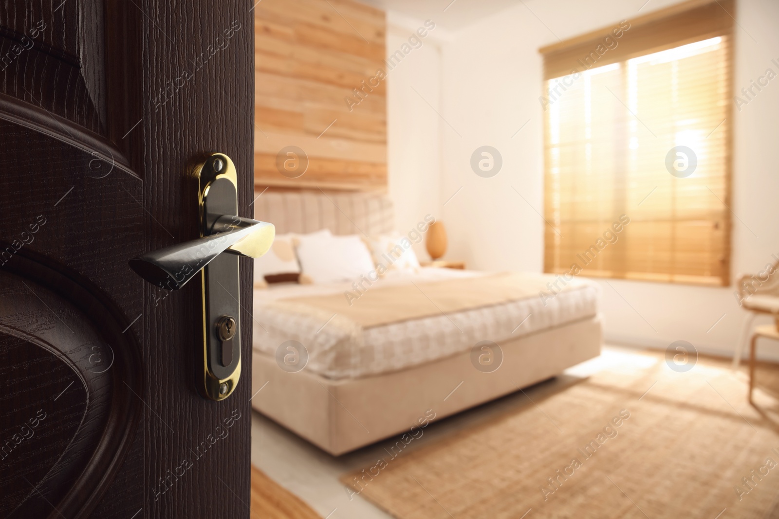 Image of Wooden door open into modern hotel room, closeup
