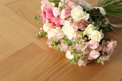 Photo of Beautiful bouquet of fresh flowers on wooden table, space for text