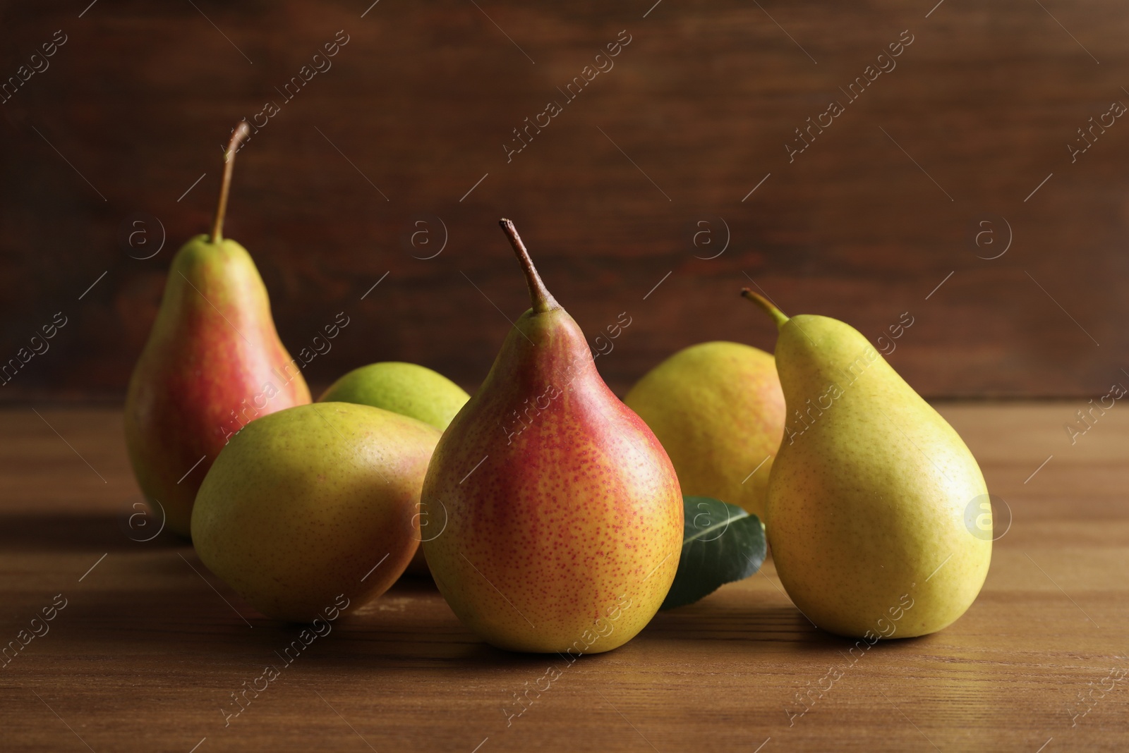 Photo of Ripe pears on wooden table. Healthy snack