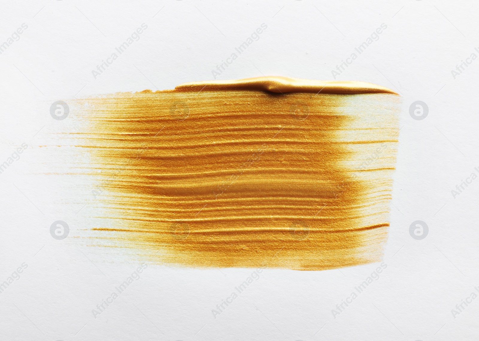 Photo of Stroke of gold paint isolated on white, top view