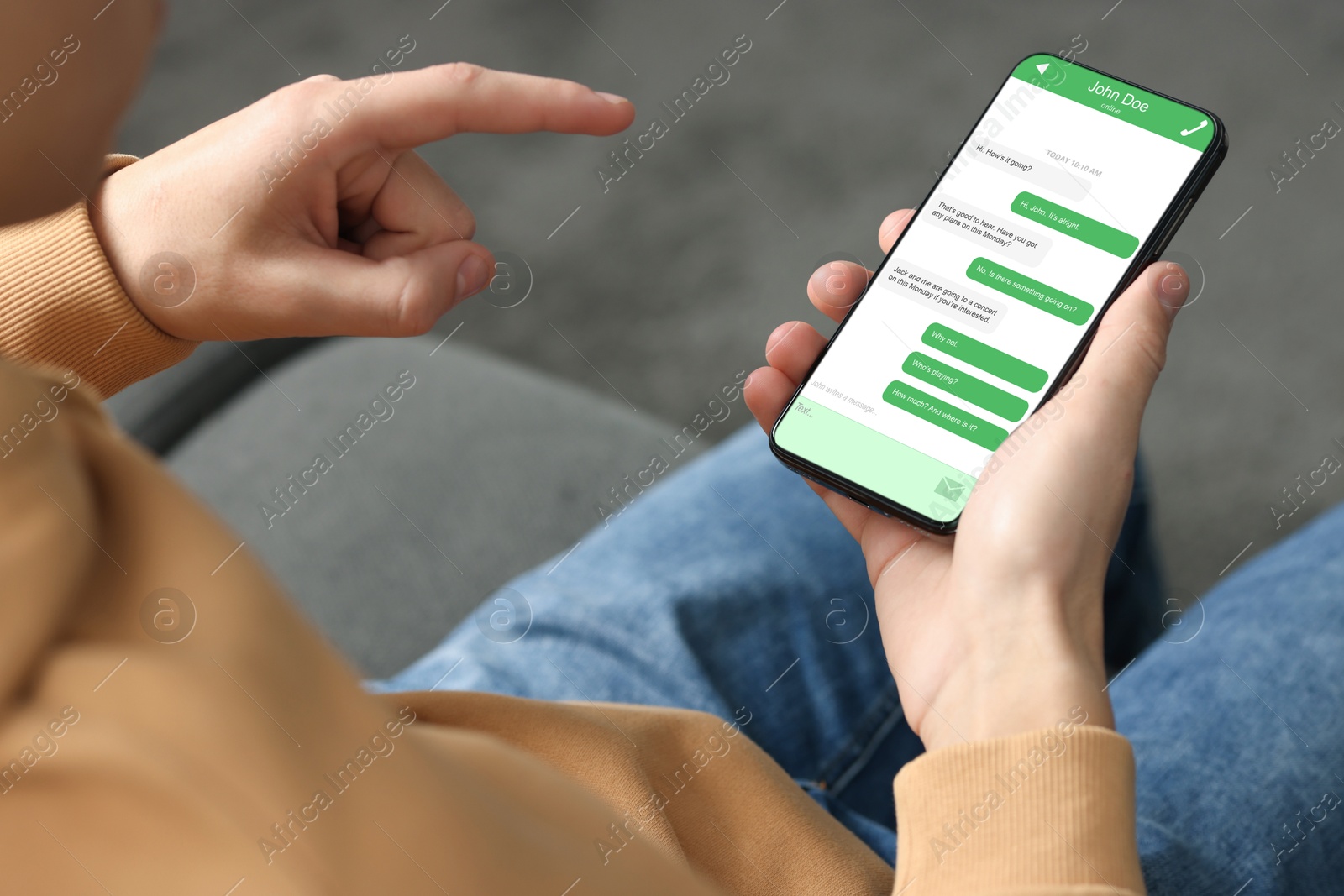 Image of Man texting via mobile phone indoors, closeup. Device screen with messages