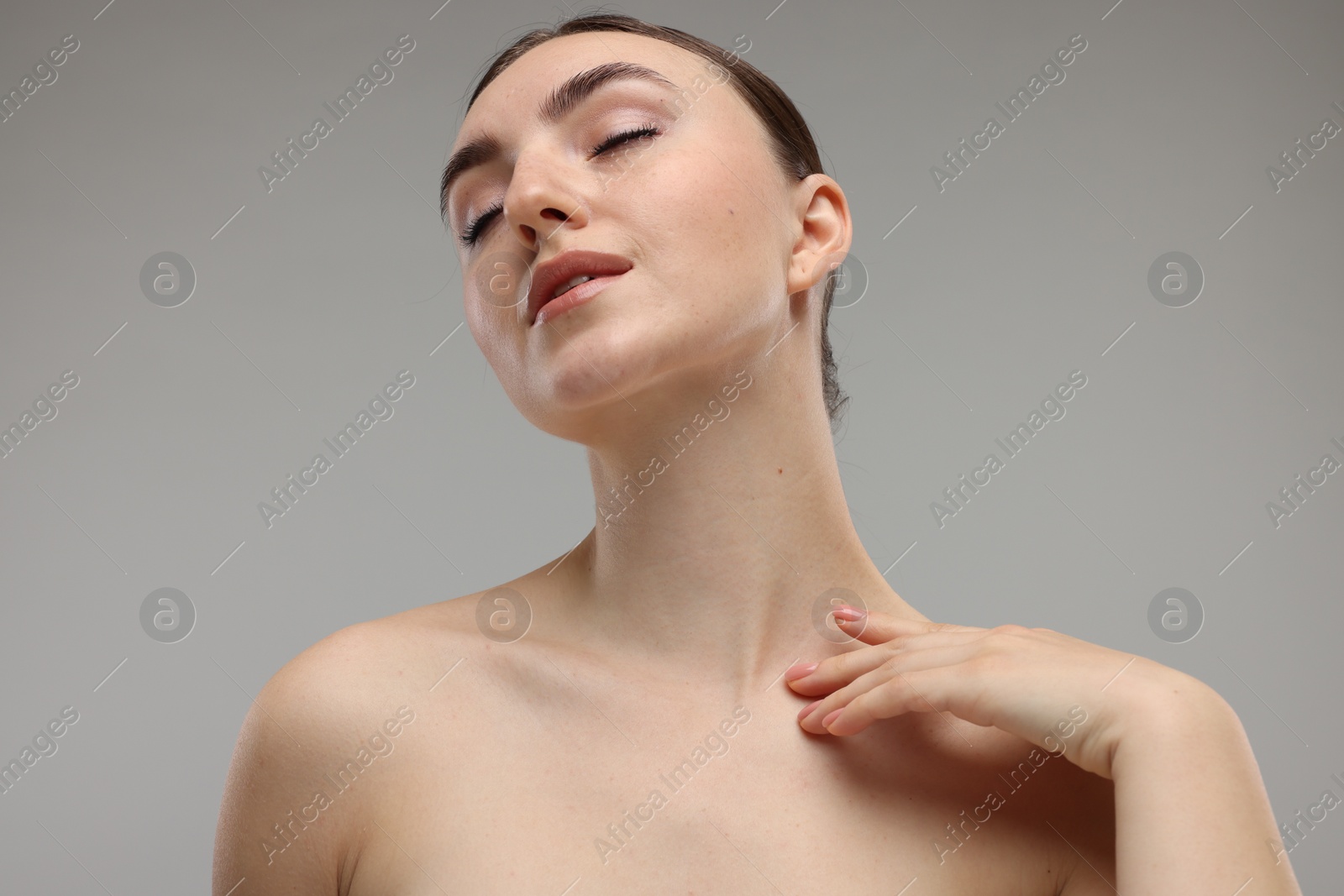 Photo of Portrait of beautiful woman on grey background