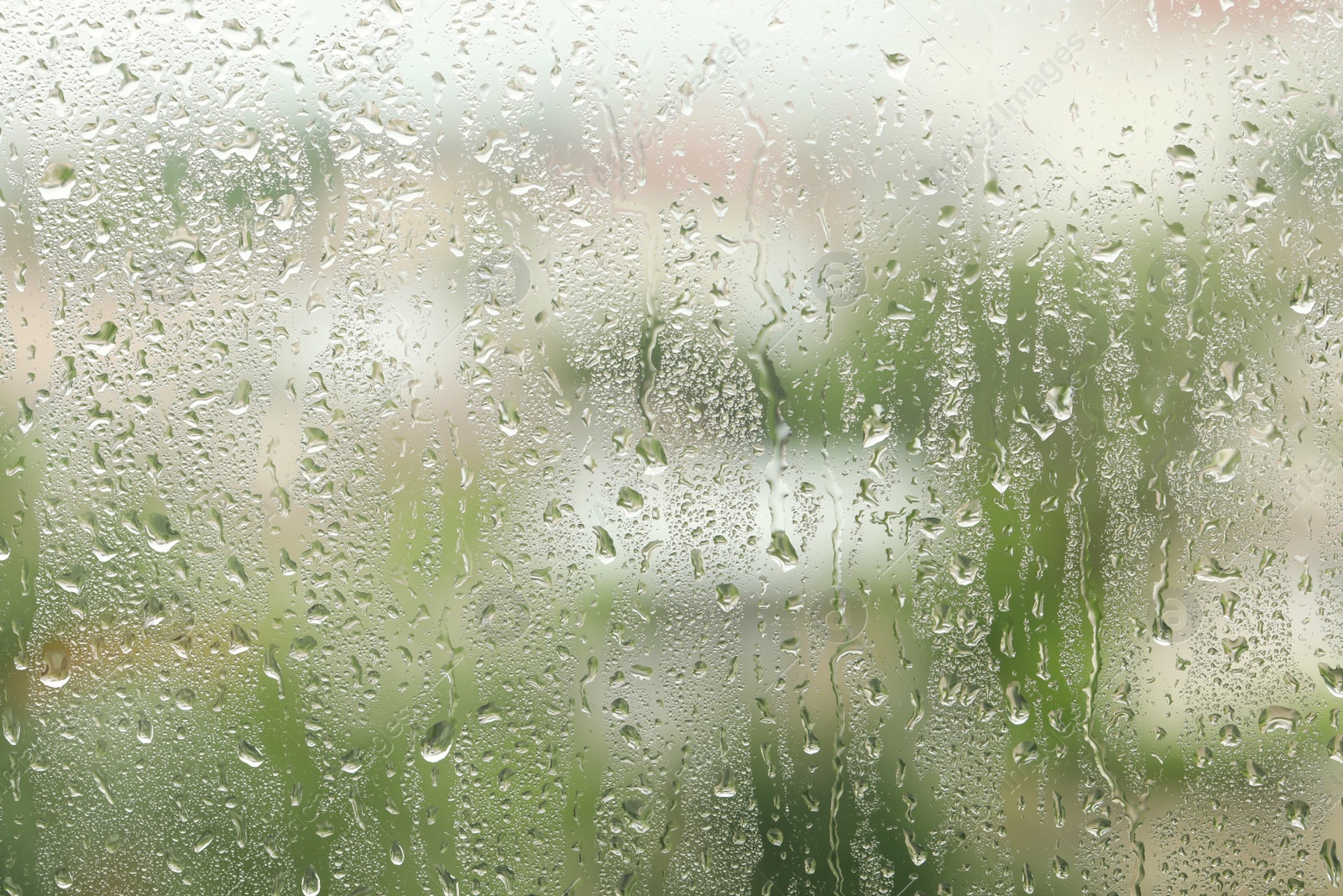 Photo of Window glass with raindrops as background, closeup