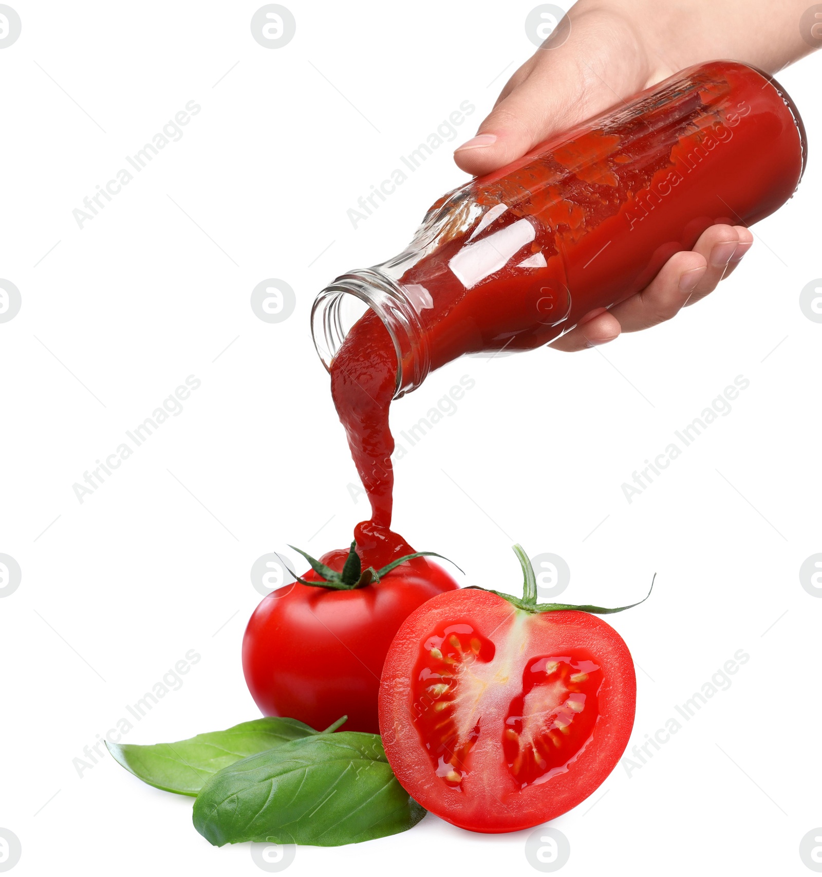 Image of Woman pouring organic ketchup onto tomato against white background, closeup