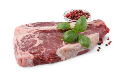 Photo of Piece of fresh beef meat with basil leaves and spices isolated on white