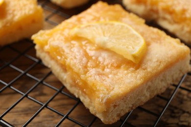 Tasty lemon bar on cooling rack, closeup