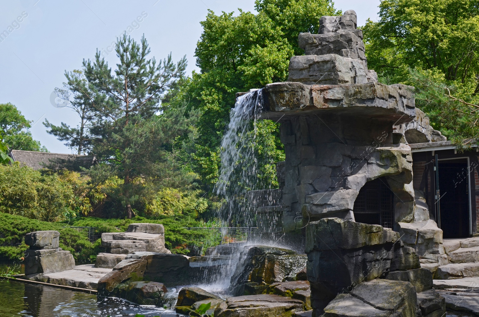 Photo of Picturesque view of waterfall and trees outdoors