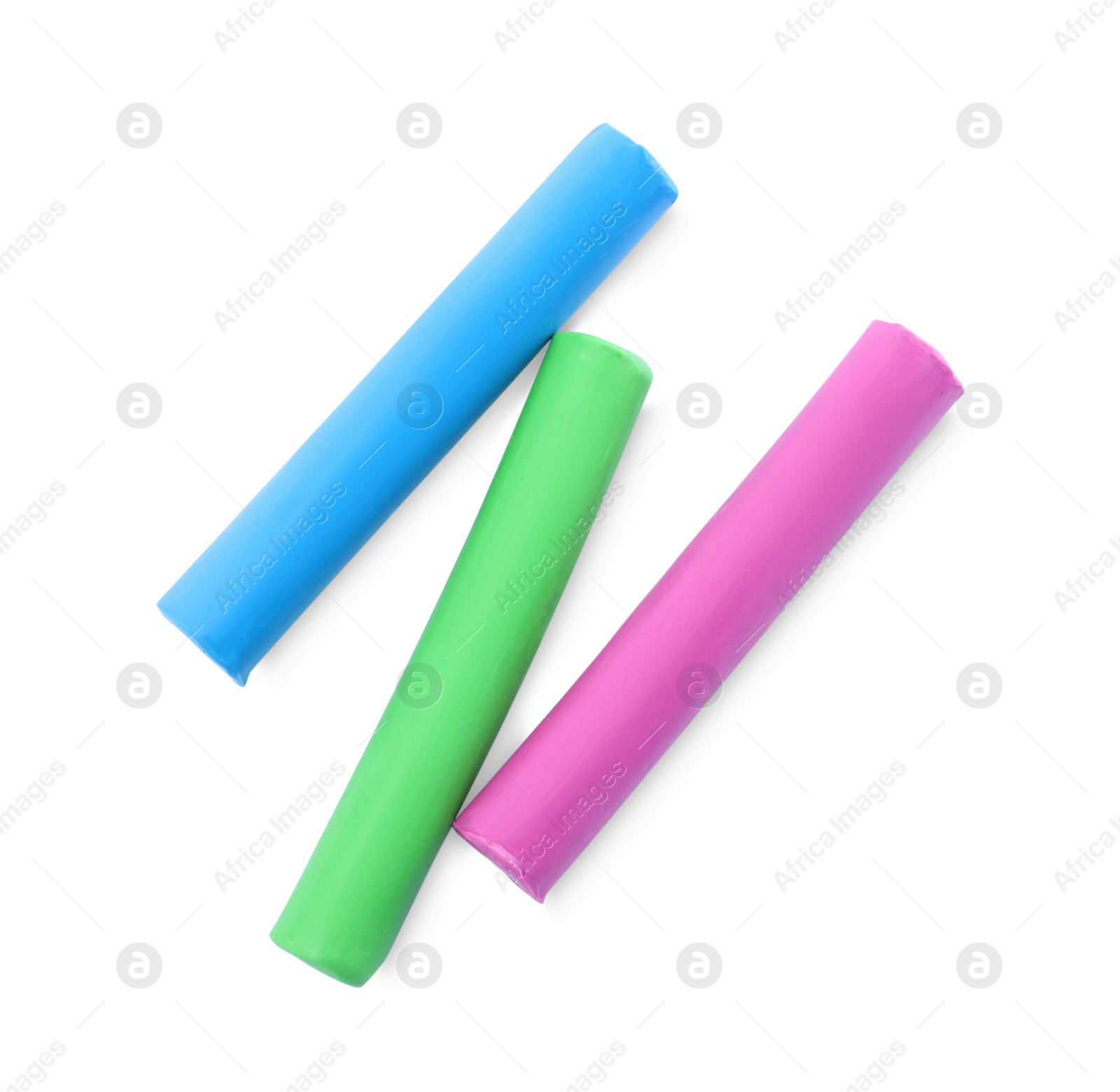 Photo of Many different colorful plasticine pieces on white background, top view