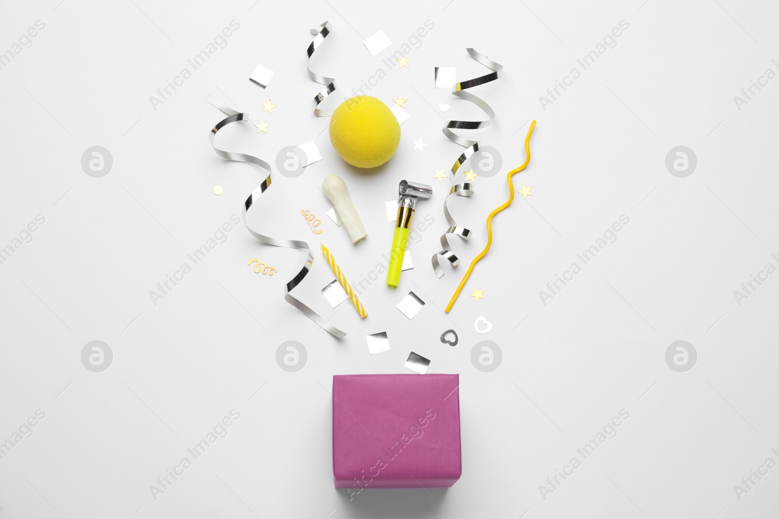 Photo of Flat lay composition with party items and box on white background