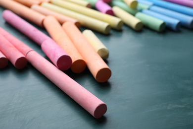 Photo of Pieces of color chalk on greenboard, closeup