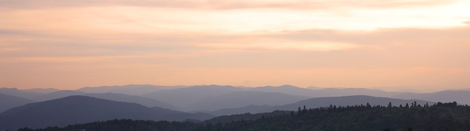 Image of Picturesque mountains under beautiful sky at sunset, banner design