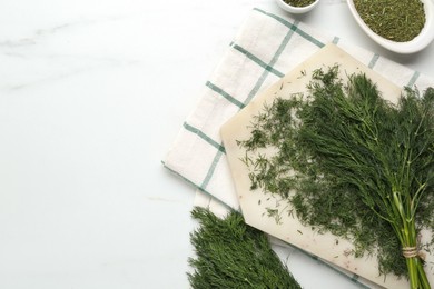 Photo of Fresh dill preparing for drying on white table, flat lay. Space for text